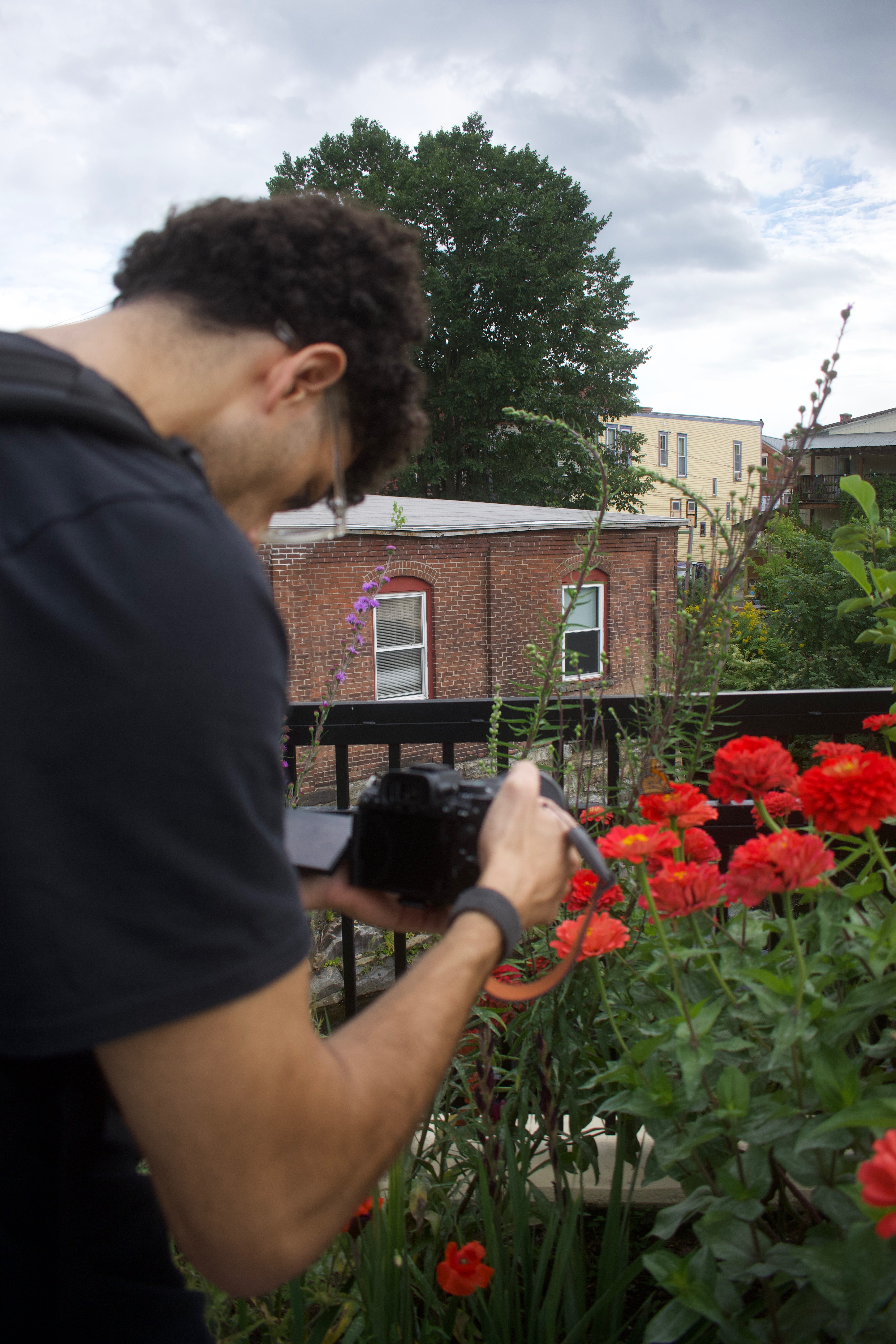 Shama photographing flowers with a camera